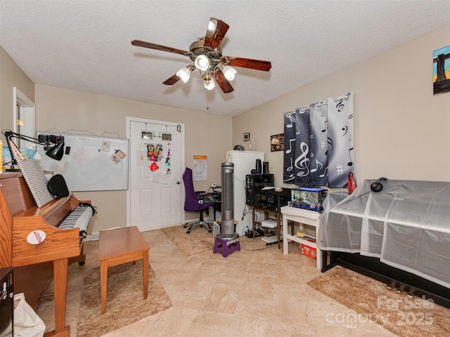 interior space featuring ceiling fan and a textured ceiling