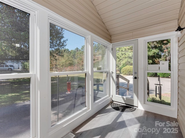 unfurnished sunroom with lofted ceiling