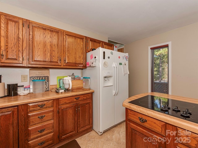 kitchen with white refrigerator with ice dispenser and black electric stovetop