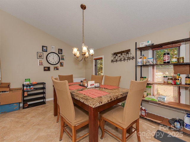 dining area featuring vaulted ceiling, an inviting chandelier, and a textured ceiling