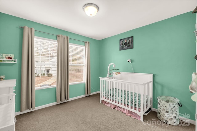 carpeted bedroom featuring a nursery area