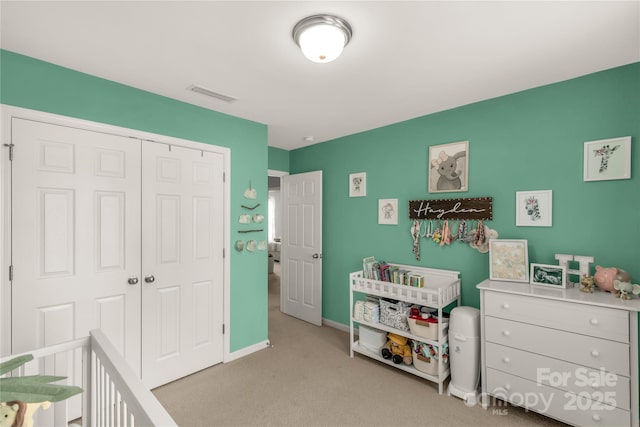 bedroom featuring a closet and light colored carpet