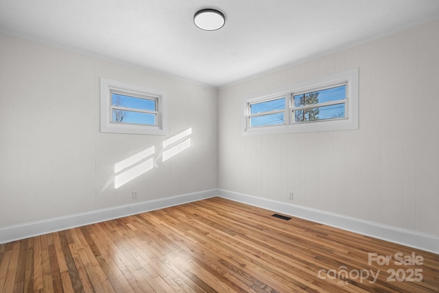 unfurnished room with wood-type flooring