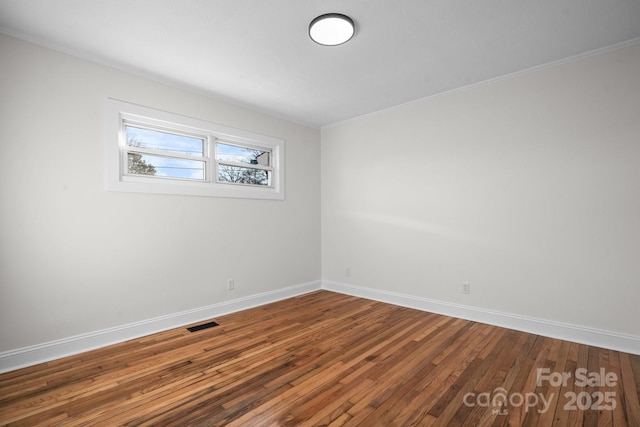 unfurnished room featuring hardwood / wood-style flooring