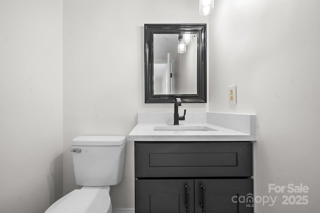 bathroom with toilet and vanity