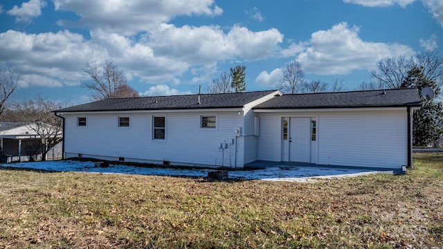 rear view of property with a lawn