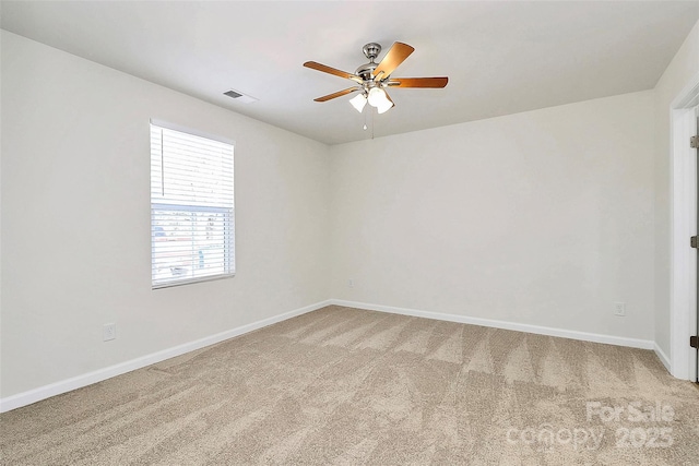 carpeted spare room with ceiling fan