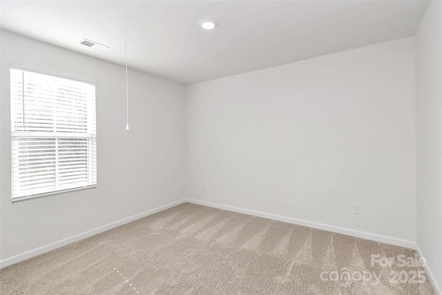 carpeted spare room with a wealth of natural light