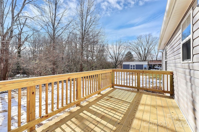 snow covered deck with a storage unit