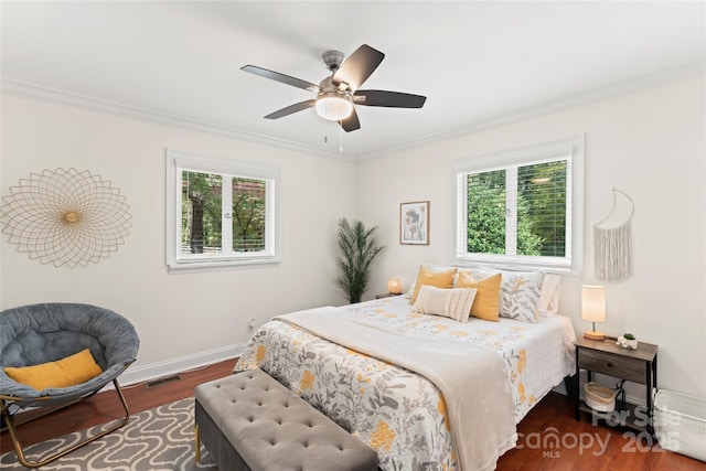 bedroom with ceiling fan, dark hardwood / wood-style floors, and crown molding