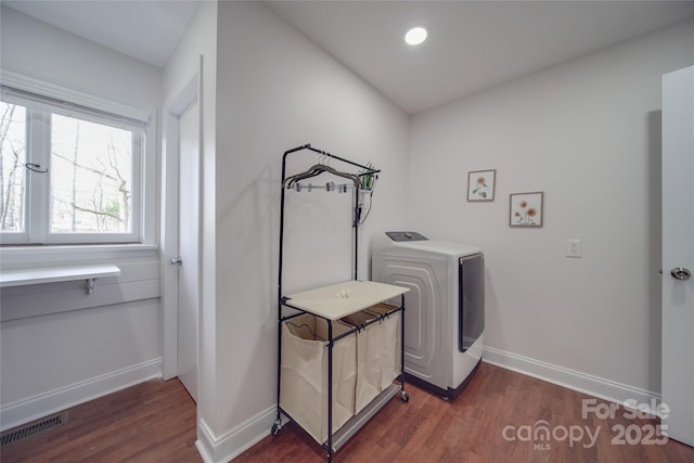 clothes washing area with washer / clothes dryer and dark hardwood / wood-style flooring