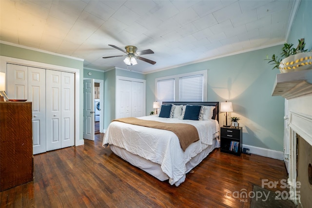 bedroom with ceiling fan, two closets, dark hardwood / wood-style flooring, and crown molding