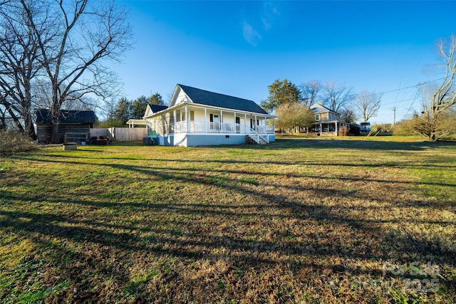 view of property exterior with covered porch, a yard, and central AC unit