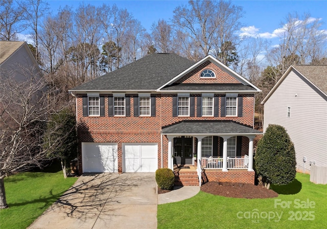 view of front facade featuring a garage, covered porch, and a front yard