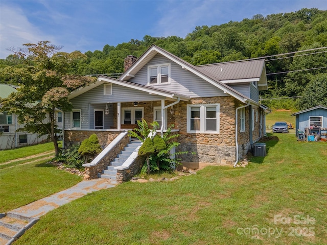 view of front facade with covered porch, a front yard, and central air condition unit