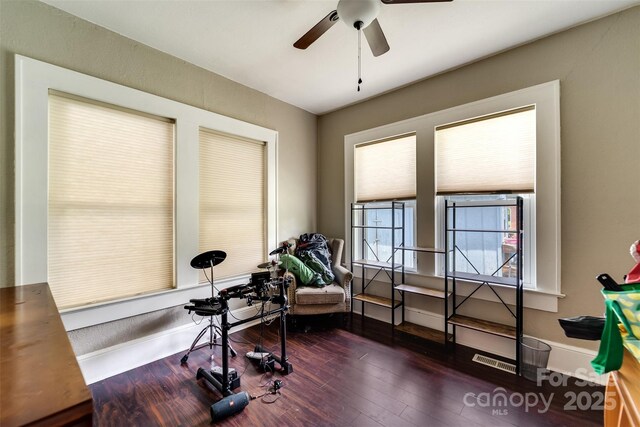 exercise area with ceiling fan and dark hardwood / wood-style floors