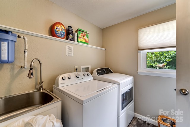 washroom with sink and washer and clothes dryer