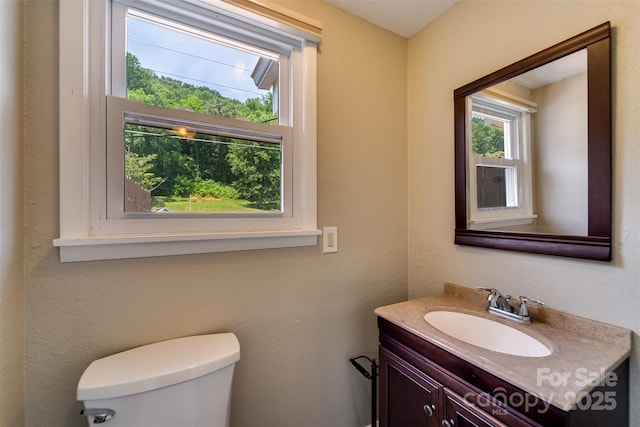 bathroom featuring toilet and vanity