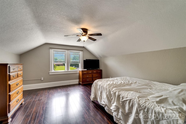 bedroom with lofted ceiling, a textured ceiling, ceiling fan, and dark hardwood / wood-style flooring