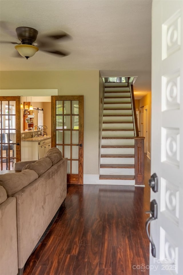 living room featuring sink, dark hardwood / wood-style floors, ceiling fan, and french doors