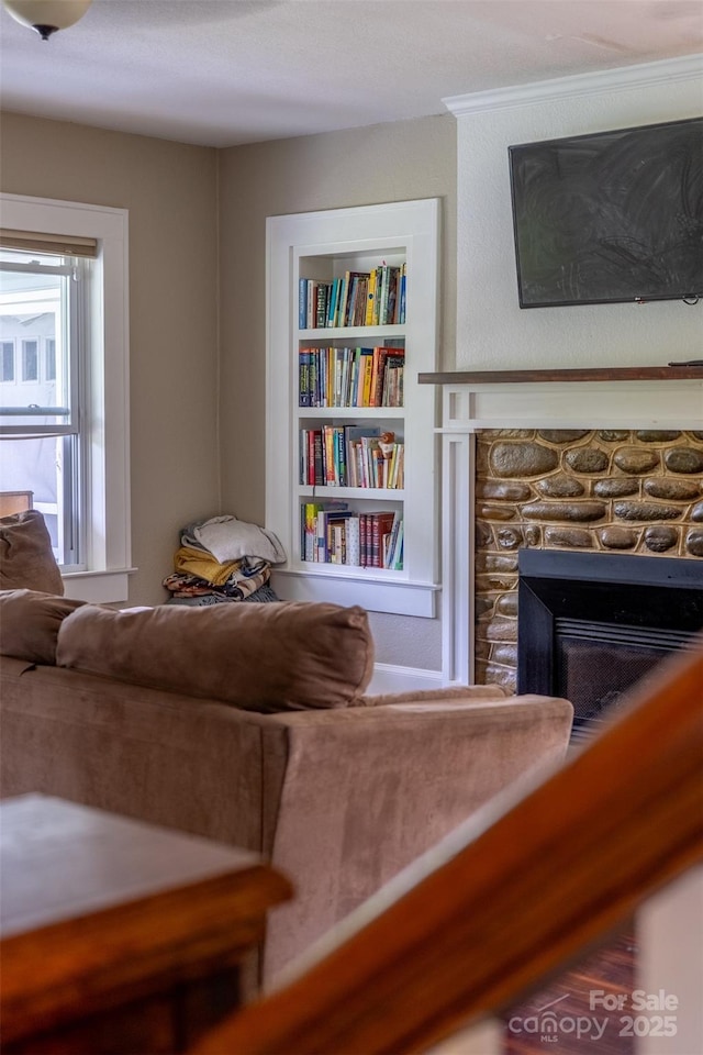 sitting room with built in features and a fireplace