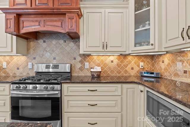 kitchen featuring cream cabinets, wine cooler, and stainless steel range with gas stovetop