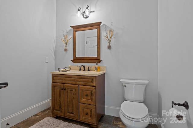 bathroom with toilet and vanity