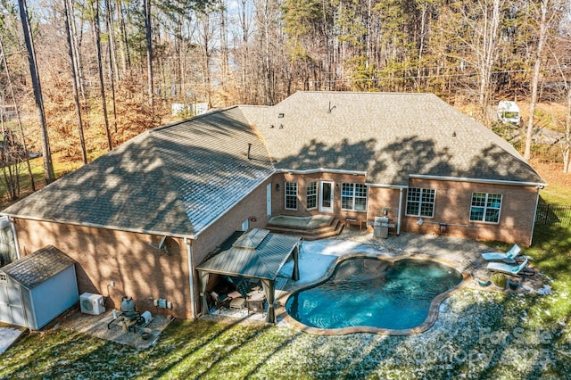 back of property with a yard, a storage shed, a patio, and central air condition unit