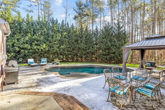 view of pool featuring grilling area, a patio area, and a gazebo