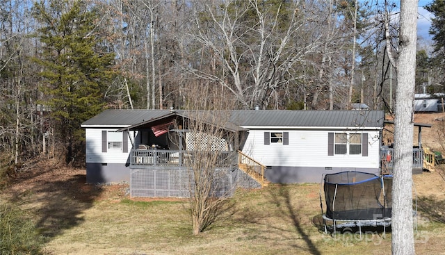 view of outdoor structure with stairway and a trampoline