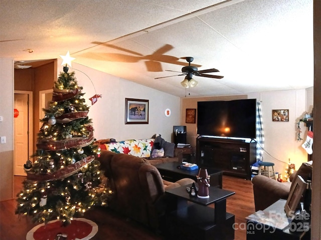 living area featuring a textured ceiling, wood finished floors, a ceiling fan, and vaulted ceiling