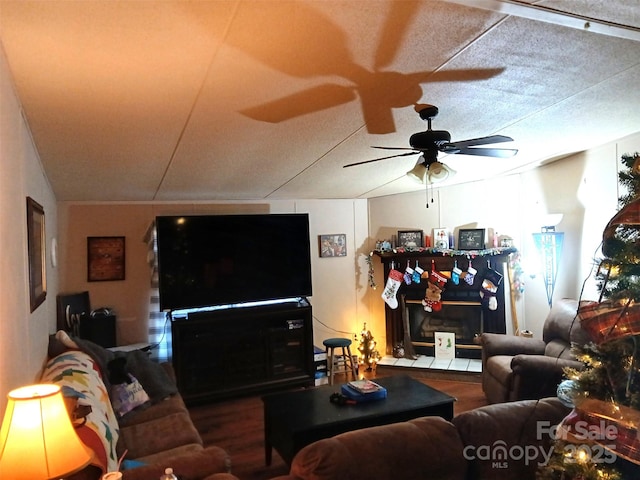 living room with wood-type flooring, a textured ceiling, and ceiling fan