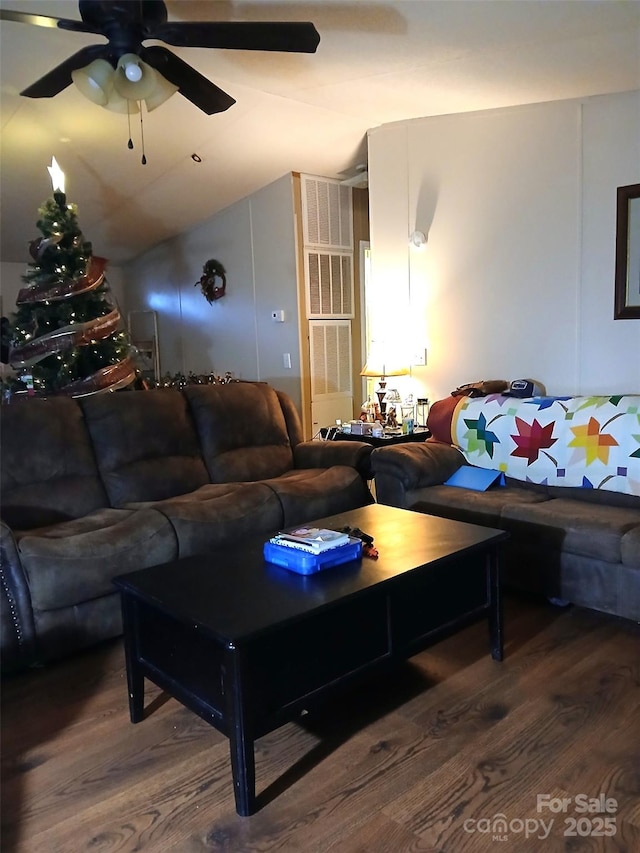 living room with a ceiling fan, vaulted ceiling, and wood finished floors