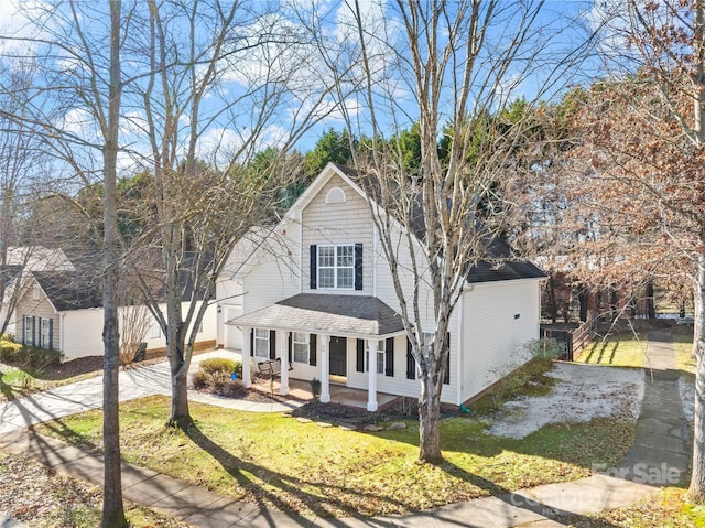 front facade with a front lawn and a porch