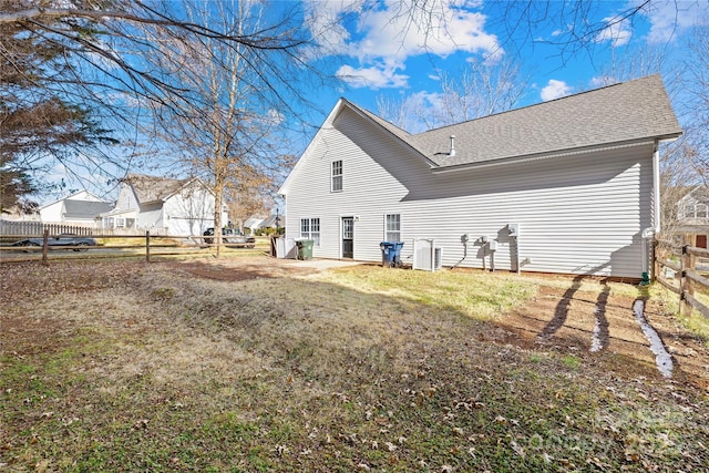 rear view of house with a lawn