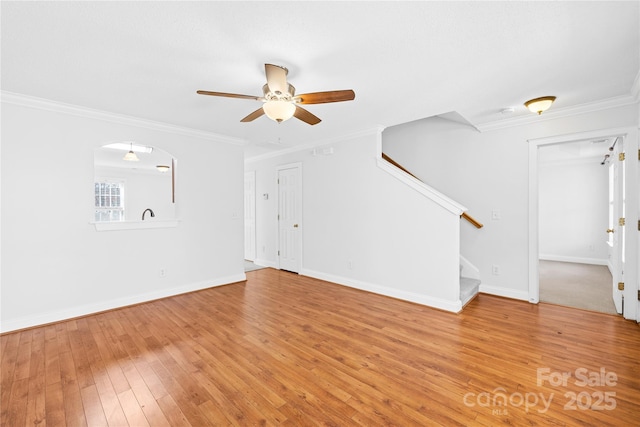 unfurnished living room with ceiling fan, crown molding, and hardwood / wood-style floors