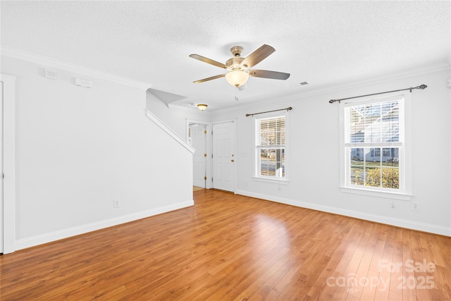 interior space with a textured ceiling, ceiling fan, crown molding, and light hardwood / wood-style flooring