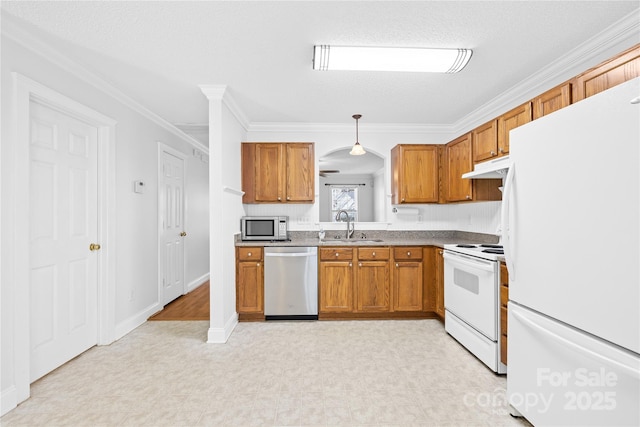 kitchen with a textured ceiling, decorative light fixtures, stainless steel appliances, sink, and crown molding