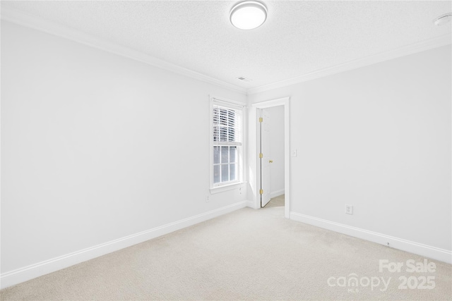 unfurnished room with light carpet, a textured ceiling, and crown molding