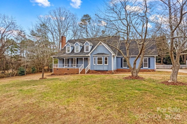 cape cod home featuring a porch and a front lawn