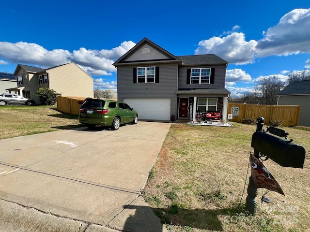traditional home featuring a front lawn, fence, a garage, and concrete driveway