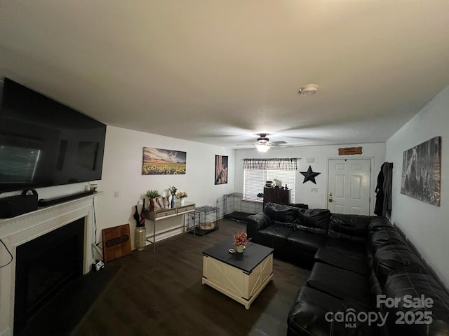 living room with ceiling fan and dark hardwood / wood-style floors