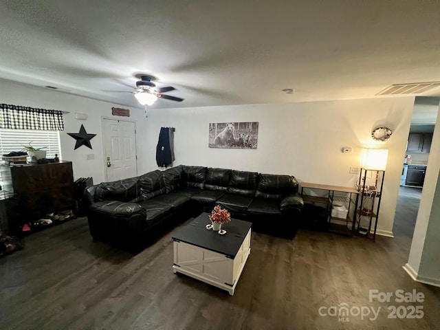 living room featuring ceiling fan and dark hardwood / wood-style floors