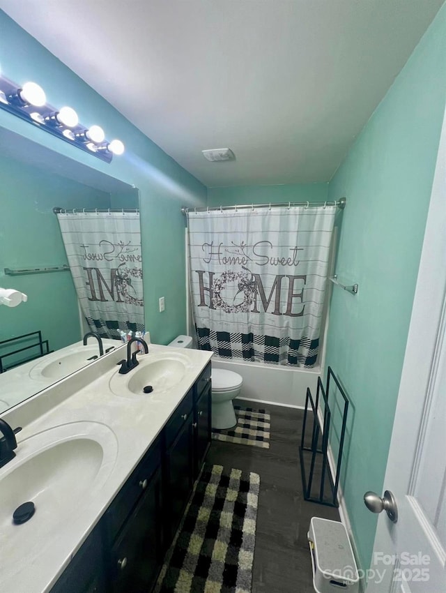 full bathroom featuring toilet, shower / bathtub combination with curtain, hardwood / wood-style floors, and vanity