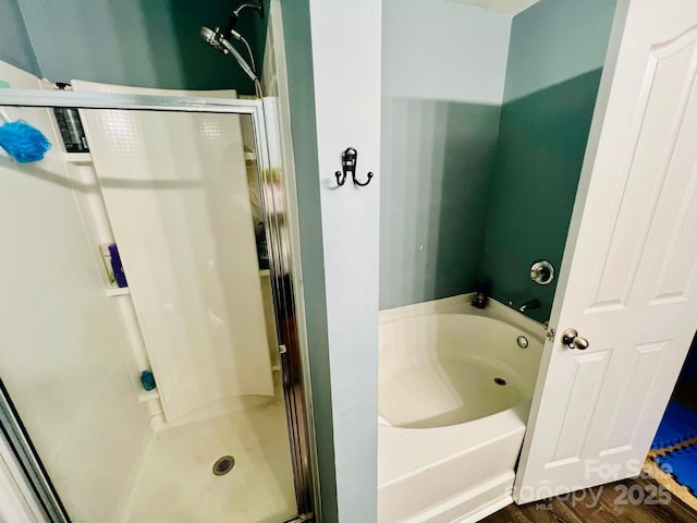 bathroom featuring independent shower and bath and hardwood / wood-style floors