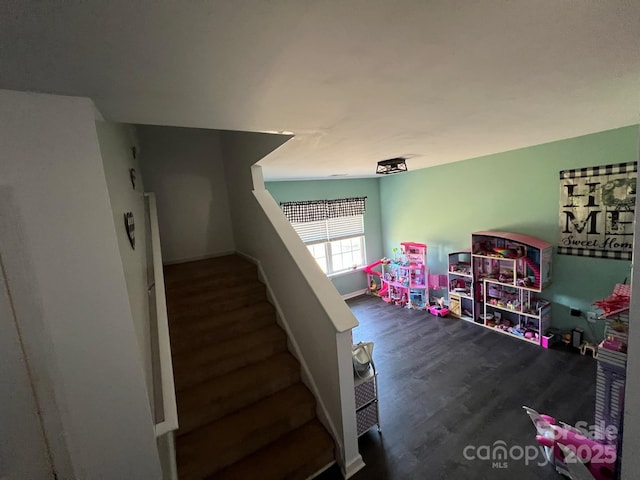 rec room with baseboards and wood finished floors