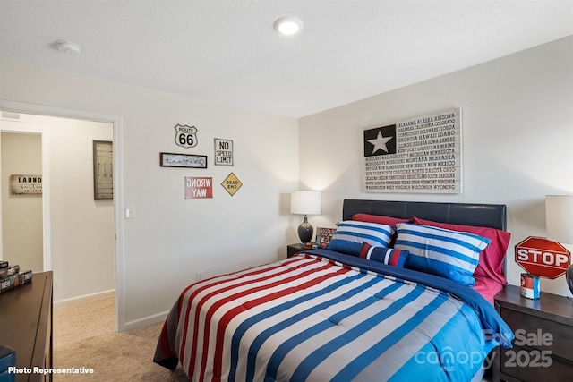 bedroom featuring light carpet