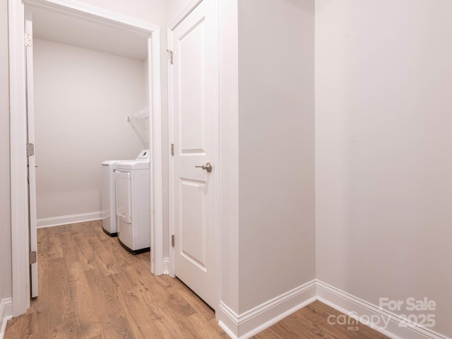 washroom featuring washer and clothes dryer and light hardwood / wood-style flooring