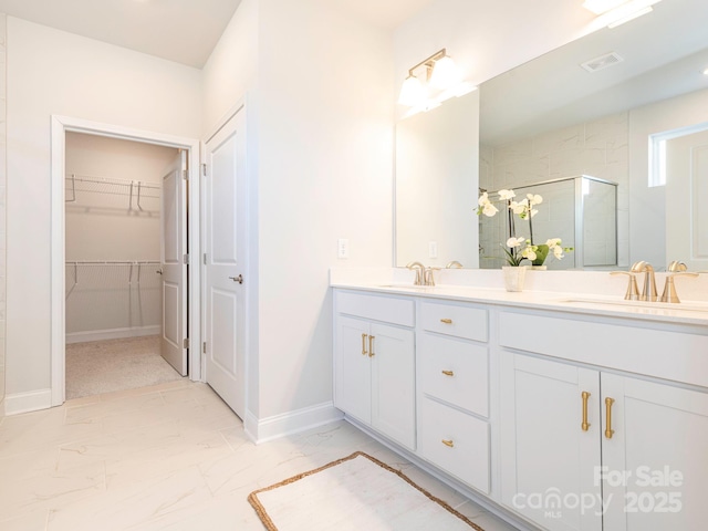 bathroom with a shower with door and vanity