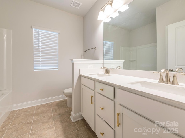 bathroom featuring toilet, tile patterned floors, and vanity